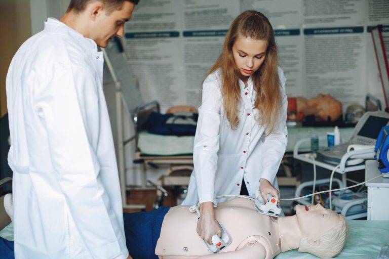 nurse conducts resuscitation doctor helps woman perform operation students practice medicine 1157 42243